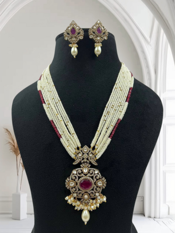 *Multiple strands of high-quality pearls *Antique-style Kundan pendant with detailed craftsmanship *Matching statement earrings included *Ideal for bridal wear, festive events, or ethnic fashion styling